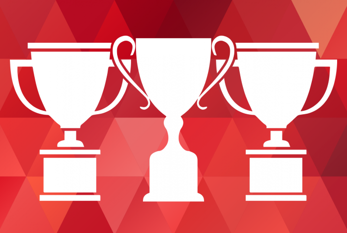 Three white trophies against a red background.